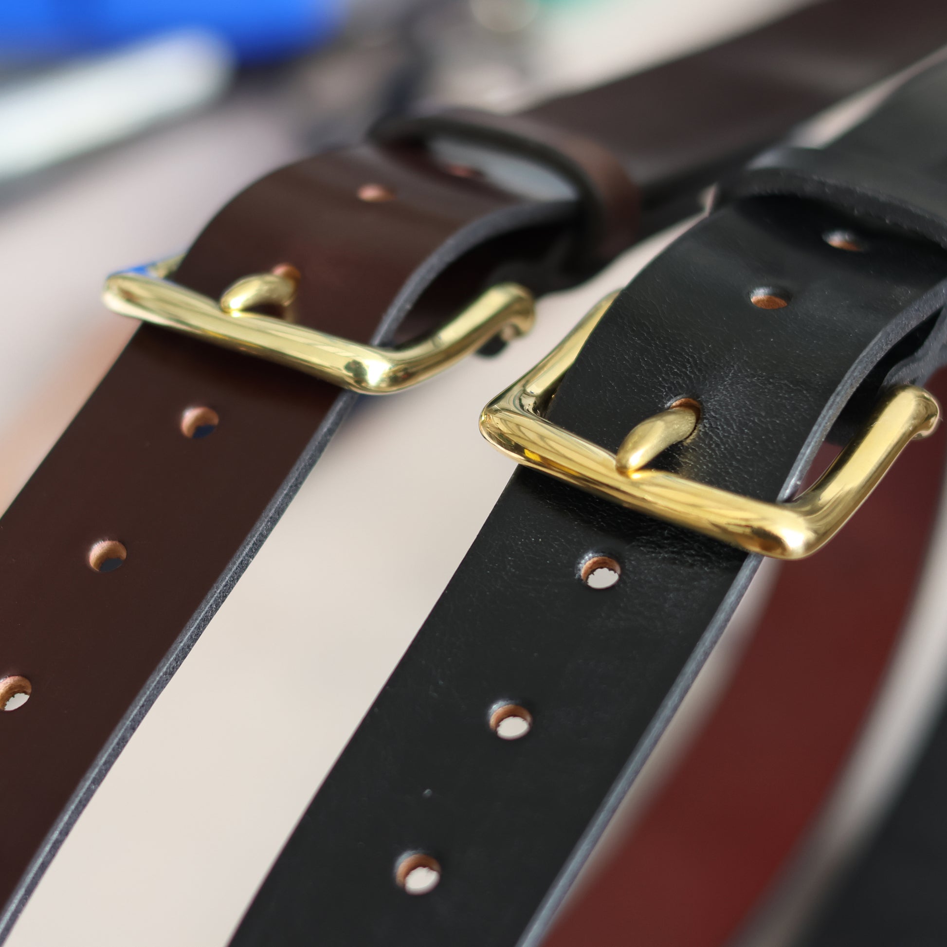 Black bridle leather belts with brass buckles