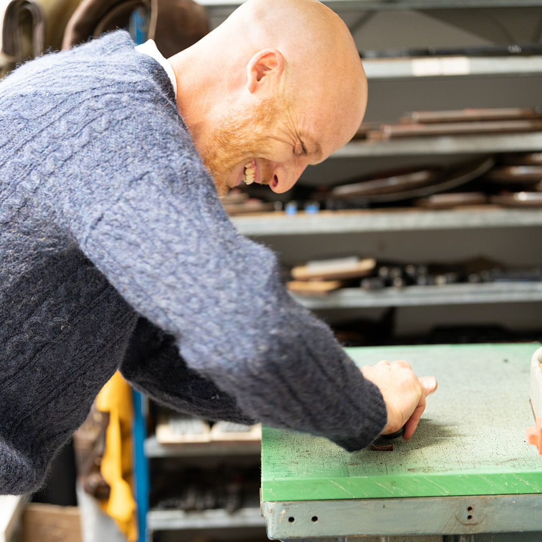 Man operating a machine in a workshop setting