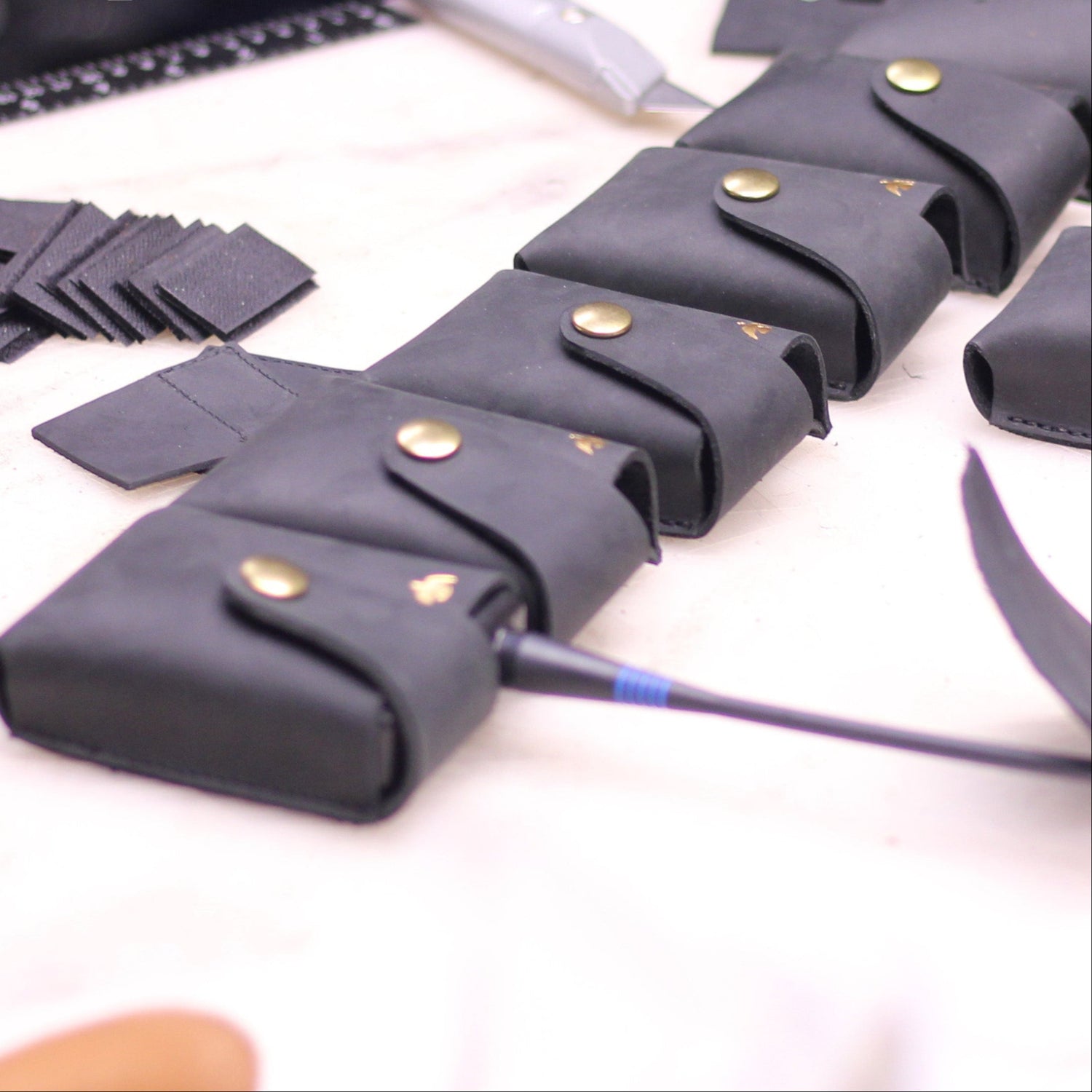 Gray falconry equipment with tools on a table, featuring 'A Clarke Falconry England' logo.
